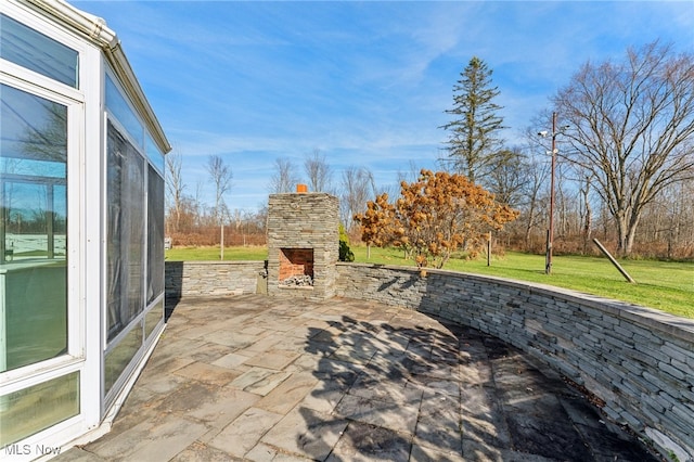 view of patio / terrace featuring an outdoor stone fireplace