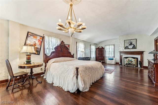 bedroom featuring multiple windows, dark hardwood / wood-style flooring, and vaulted ceiling