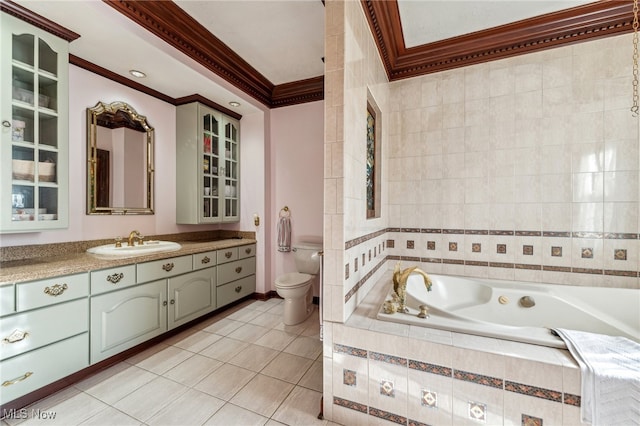 bathroom with vanity, tile patterned floors, toilet, ornamental molding, and tiled tub