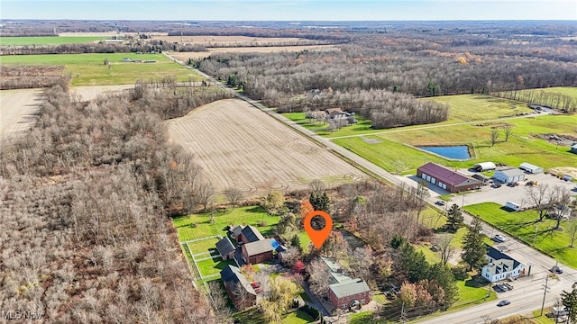 birds eye view of property with a rural view and a water view