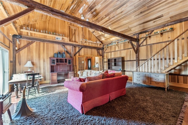 living room featuring beam ceiling, high vaulted ceiling, wooden walls, and wood ceiling