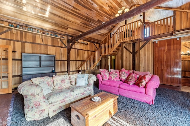 living room with vaulted ceiling with beams, wooden walls, and wooden ceiling