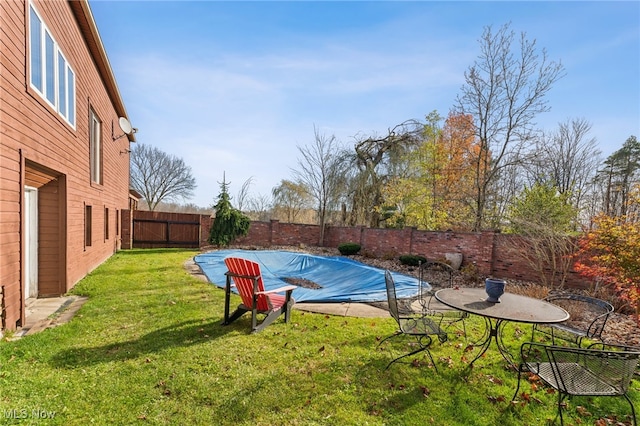 view of pool featuring a lawn