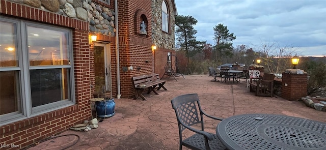 view of patio terrace at dusk