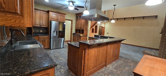 kitchen with ceiling fan, stainless steel refrigerator with ice dispenser, decorative light fixtures, decorative backsplash, and island range hood