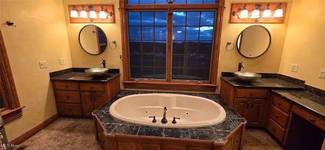 bathroom featuring vanity and a tub to relax in