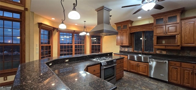 kitchen featuring sink, stainless steel appliances, backsplash, island exhaust hood, and decorative light fixtures