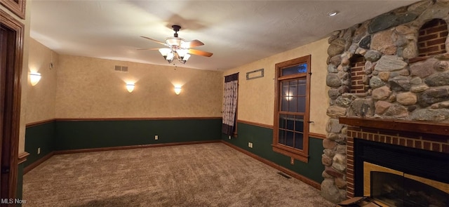 interior space featuring ceiling fan and a fireplace