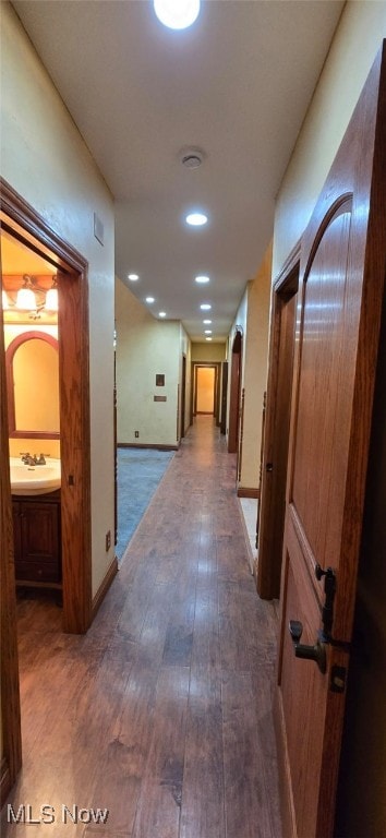 hall with dark wood-type flooring and sink