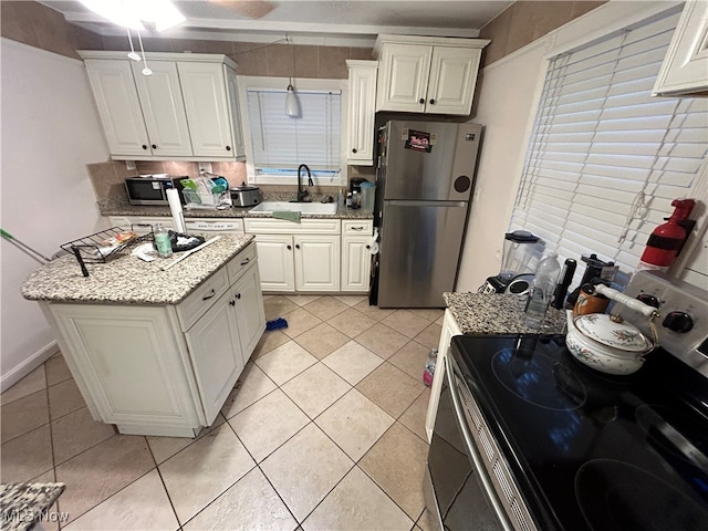 kitchen featuring light stone counters, stainless steel appliances, white cabinetry, and sink