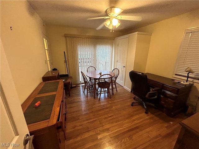 dining space featuring a textured ceiling, dark hardwood / wood-style floors, and ceiling fan