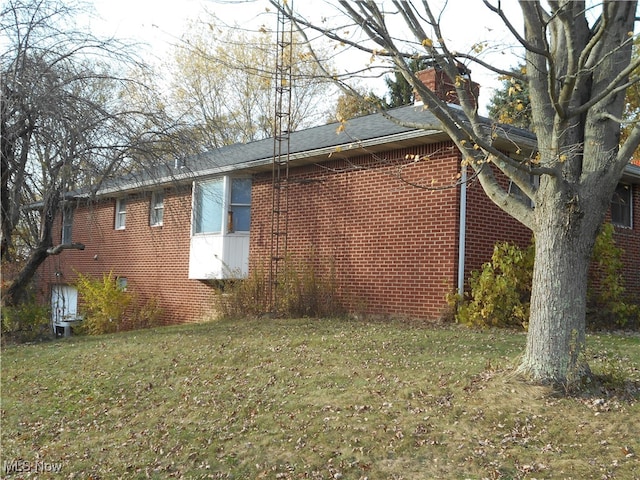 view of home's exterior with a yard