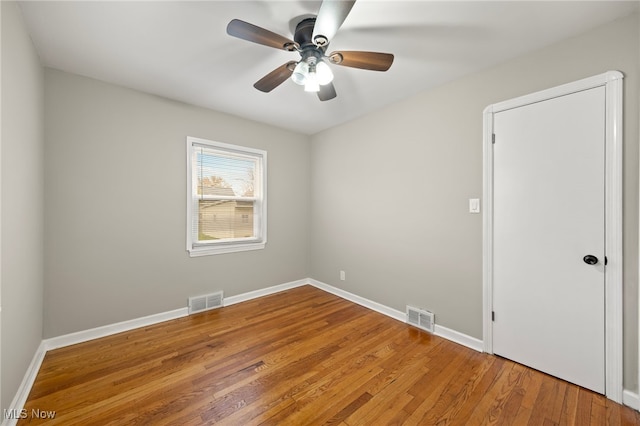 empty room featuring wood-type flooring and ceiling fan