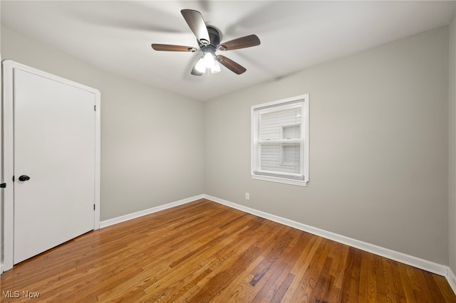 spare room featuring hardwood / wood-style flooring and ceiling fan