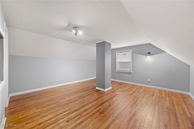 bonus room featuring light hardwood / wood-style flooring and lofted ceiling