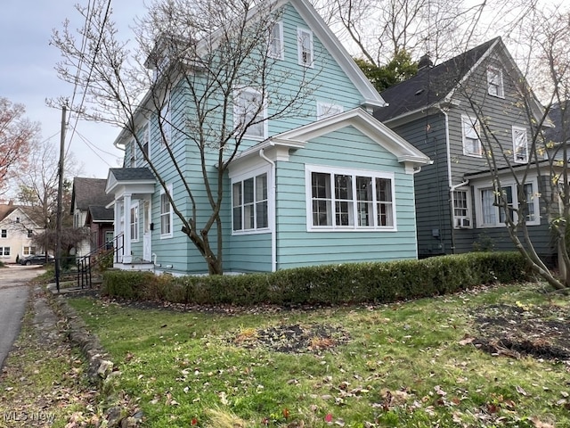 view of side of property with a yard