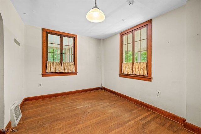 spare room with hardwood / wood-style flooring