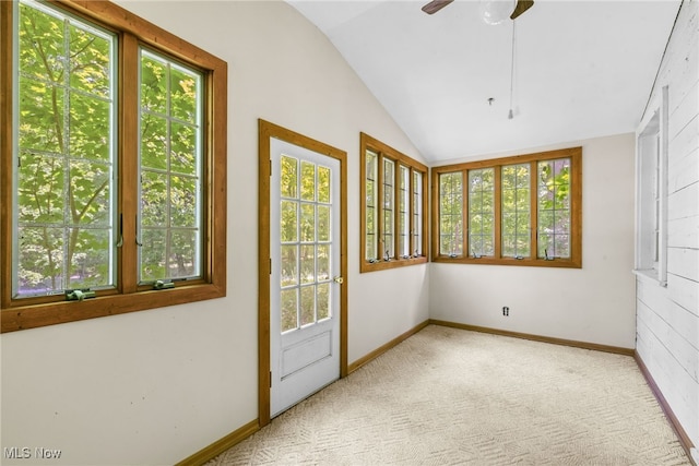 unfurnished sunroom featuring ceiling fan and vaulted ceiling