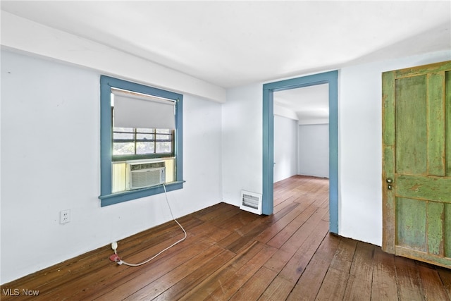 empty room with cooling unit and dark wood-type flooring