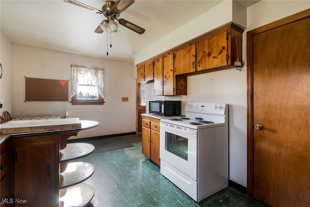 kitchen featuring white electric stove and ceiling fan