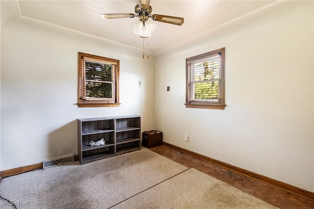 carpeted spare room featuring ceiling fan