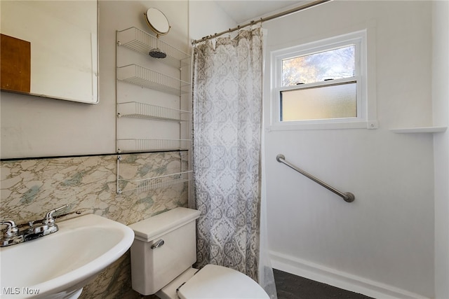 bathroom featuring sink, a shower with shower curtain, tile walls, and toilet