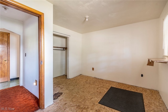 unfurnished bedroom featuring a closet and carpet