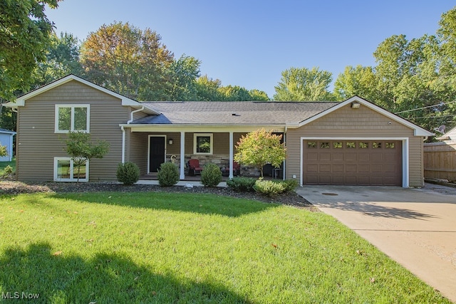 view of front of house featuring a front lawn, a porch, and a garage