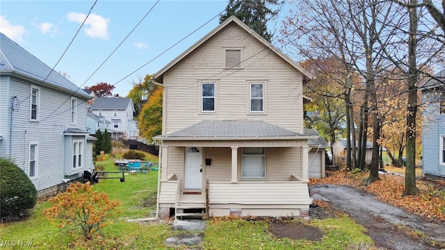 view of front of home featuring covered porch and a front yard