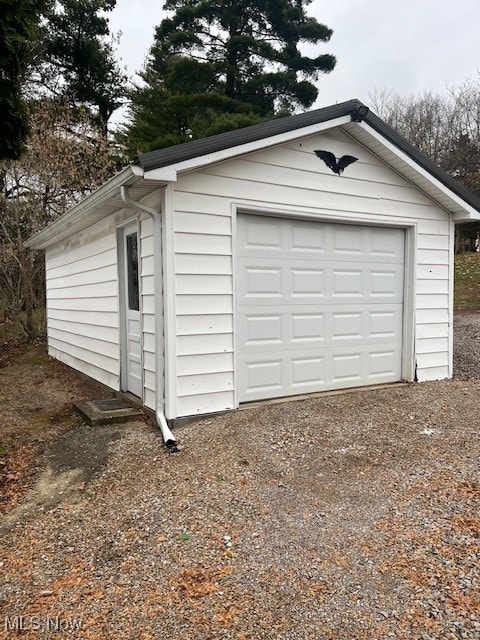 detached garage featuring driveway