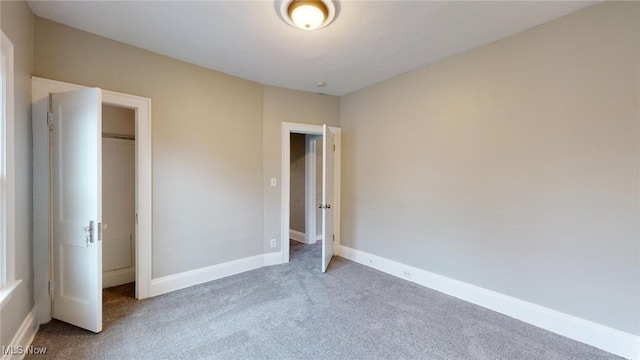 unfurnished bedroom with carpet flooring and a closet