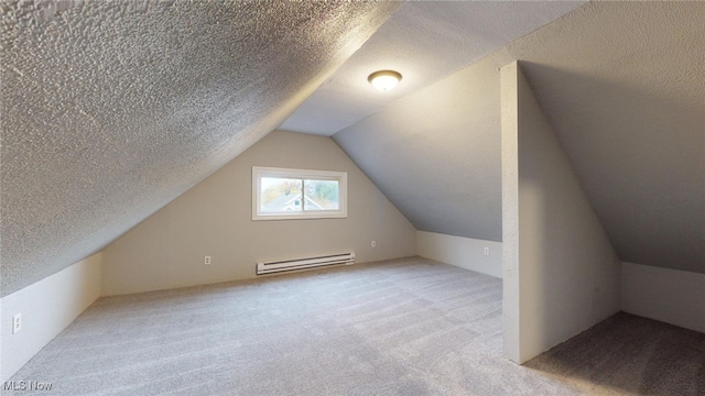 bonus room featuring baseboard heating, a textured ceiling, light colored carpet, and lofted ceiling