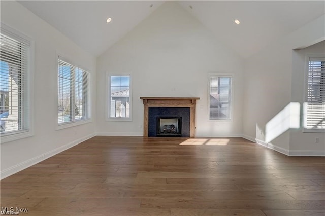 unfurnished living room with dark hardwood / wood-style floors and high vaulted ceiling