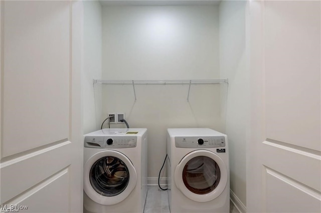 laundry area with washing machine and clothes dryer