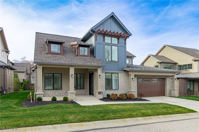 view of front of home with a porch, a garage, and a front lawn