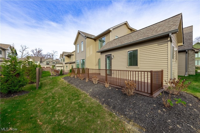 rear view of property with a lawn