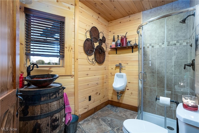 bathroom with sink, wooden ceiling, wood walls, toilet, and a shower with shower door