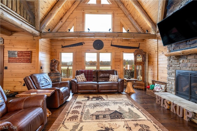 living room with a stone fireplace, wood walls, high vaulted ceiling, and dark hardwood / wood-style floors