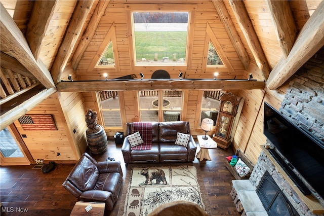 unfurnished living room with wood walls, a stone fireplace, vaulted ceiling with beams, dark hardwood / wood-style floors, and wood ceiling