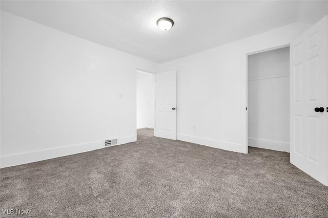 unfurnished bedroom featuring carpet, a closet, visible vents, and baseboards