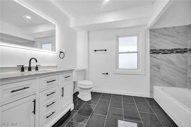 bathroom featuring toilet, vanity, and baseboards