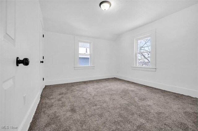 carpeted spare room with baseboards