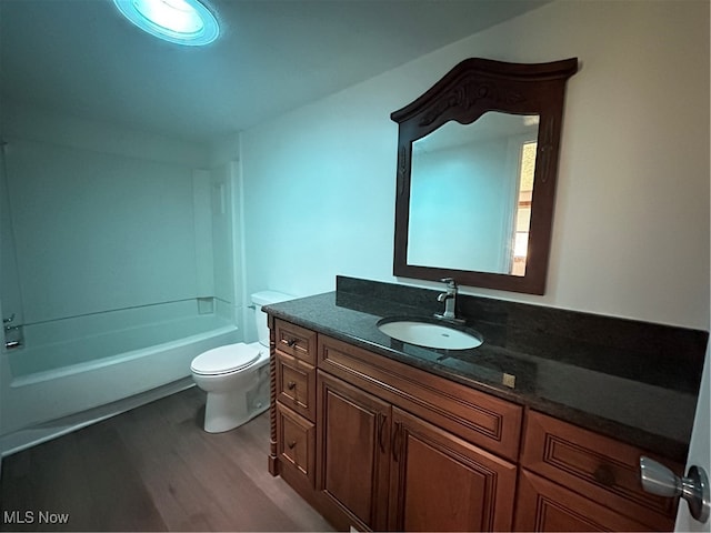 full bathroom with hardwood / wood-style floors, vanity, shower / bath combination, and toilet