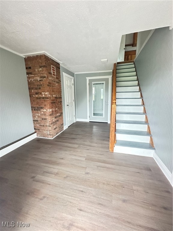 interior space featuring a textured ceiling and hardwood / wood-style flooring