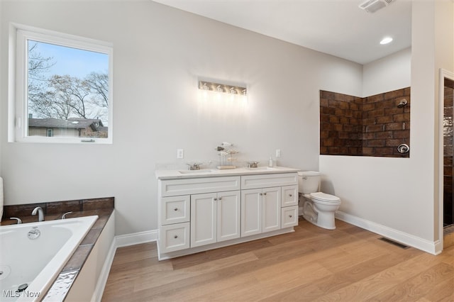 full bathroom featuring independent shower and bath, vanity, wood-type flooring, and toilet