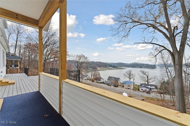 balcony featuring a deck with water view