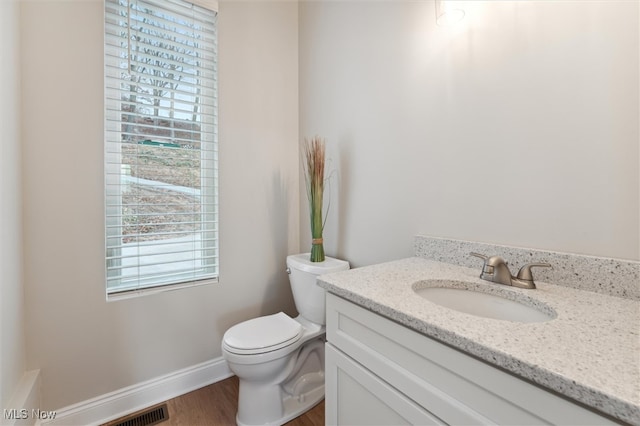 bathroom featuring hardwood / wood-style floors, vanity, and toilet