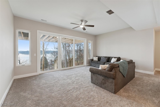 carpeted living room with ceiling fan