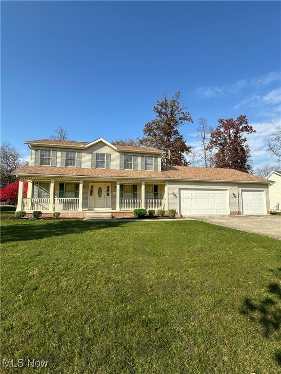 view of front of home with a front yard, a porch, and a garage