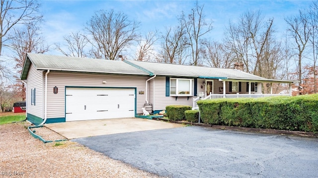 single story home featuring a porch and a garage